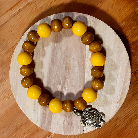 NOOK & CANDLE Jewelry Boutique Elastic Bracelet yellow and tan beaded Bracelet with turtle Charm