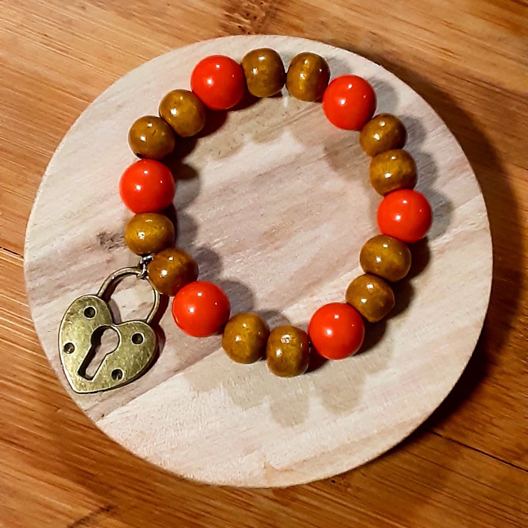 NOOK & CANDLE Jewelry Boutique big orange and tan Elastic Bracelet with lock Charm