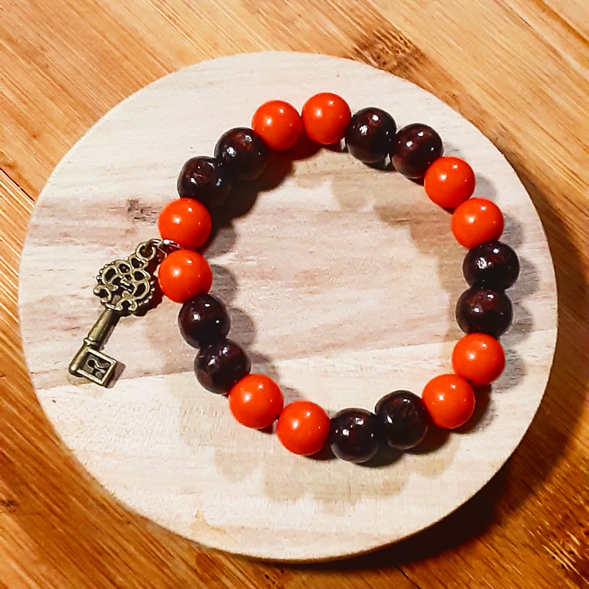 NOOK & CANDLE Jewelry Boutique Chocolate and orange beaded Elastic Bracelet with charm key